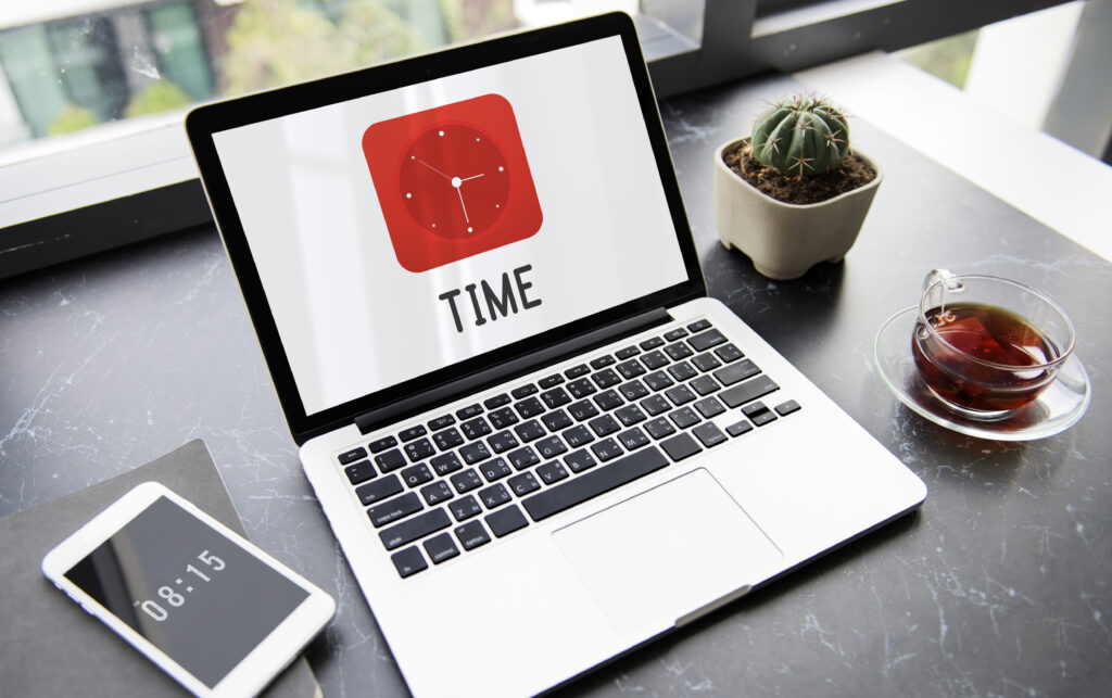 time clock graphics icon symbol - Metro Offices A virtual office with a laptop displaying the word time.