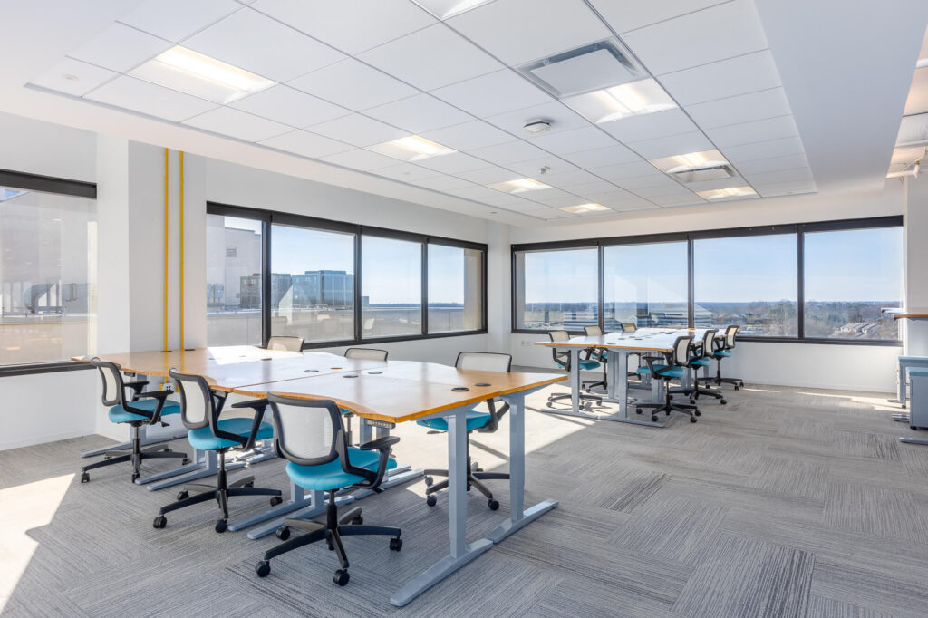 MetroOffices Tysons 7 - Metro Offices A conference room with tables and chairs in suites.
