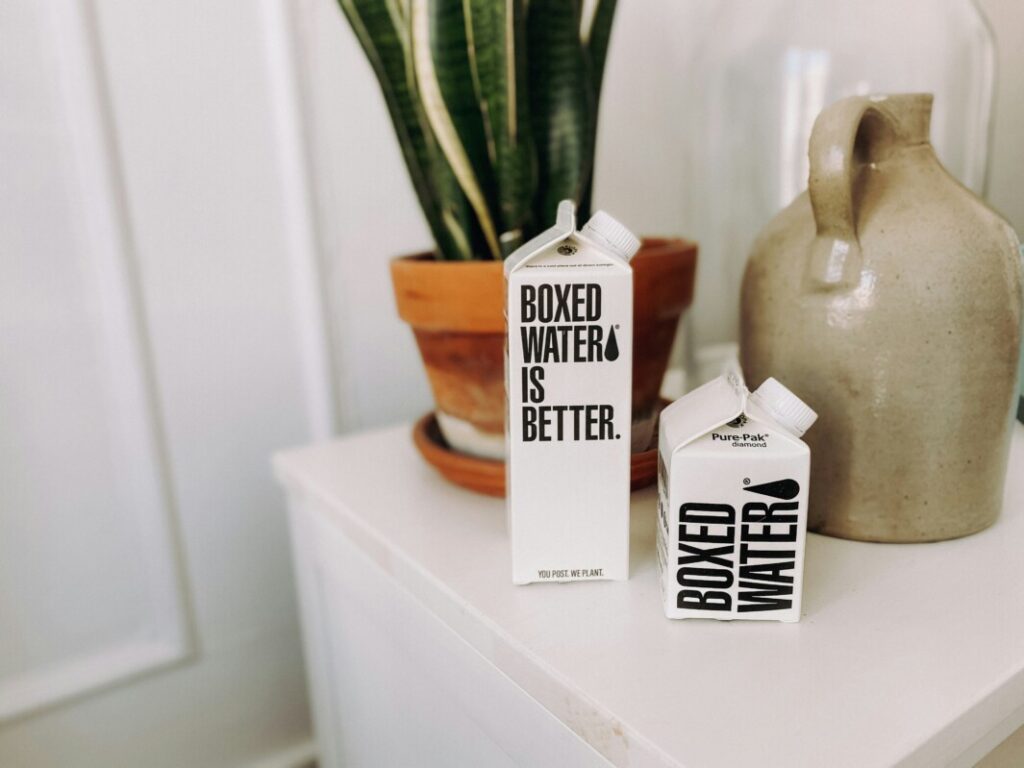 boxed water is better HEXirPkf1hI unsplash - Metro Offices A box of baked goods sits on an eco-friendly table next to a plant in a private office.