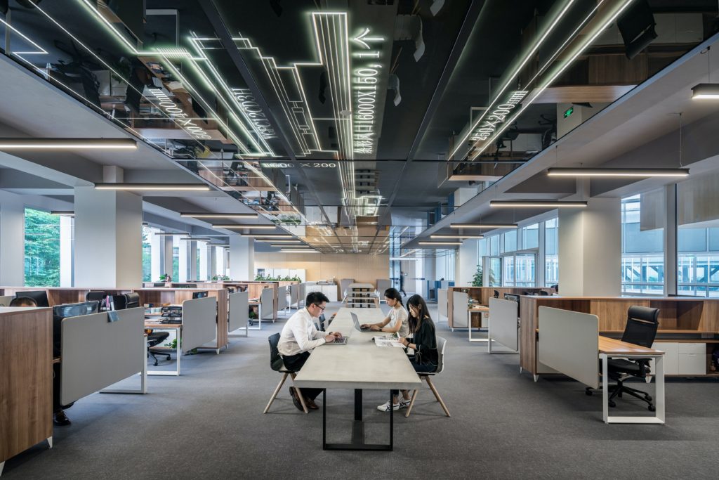 lycs architecture U2BI3GMnSSE unsplash - Metro Offices People sitting around a big office space.