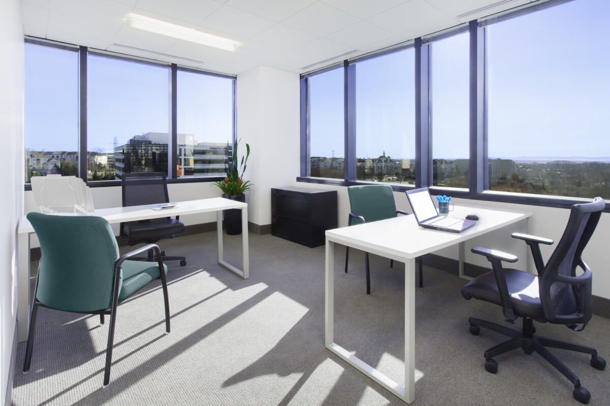 ?seraph accel gi=wp content%2Fuploads%2F2024%2F07%2F002 DO - Metro Offices A bright office with two desks, chairs, laptops, and a potted plant. Large windows provide natural light and a view of city buildings.