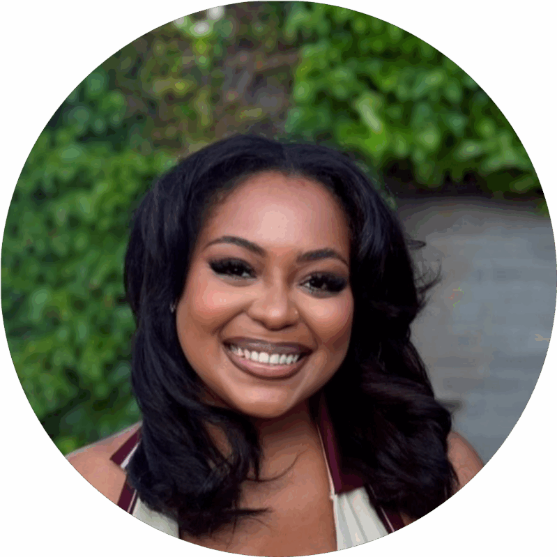 Ivory and Orange Professional Profile Photo Instagram Post 1 - Metro Offices A woman with long dark hair smiles at the camera, standing outdoors with green foliage in the background.