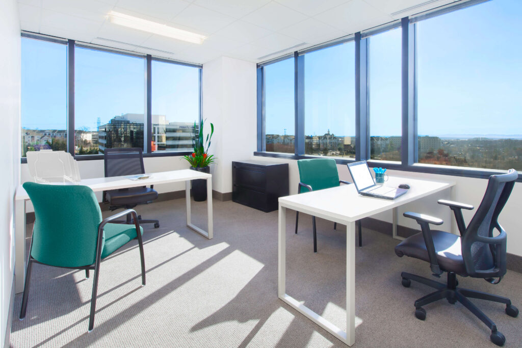 Office space with a desk and chairs offering a city view is available for rent.