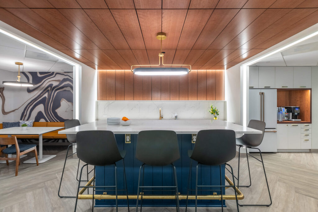 A coworking space with a wooden ceiling and bar stools.